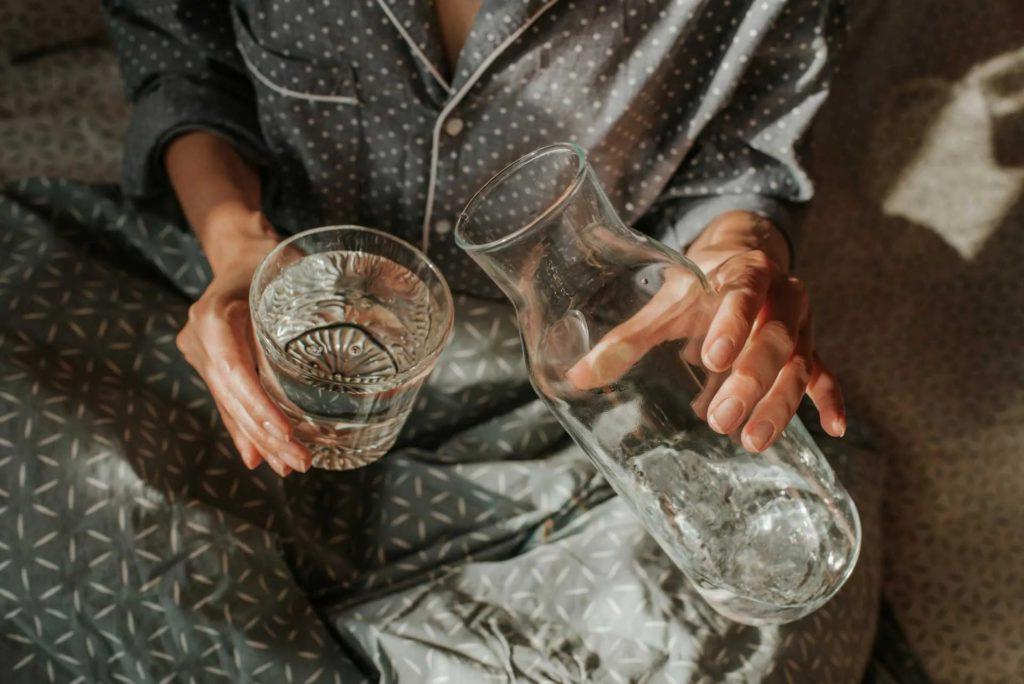 A man pouring water in a glass